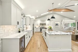 Bright modern kitchen with white cabinets and large island.