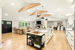 Bright modern kitchen with large island and wooden beams.