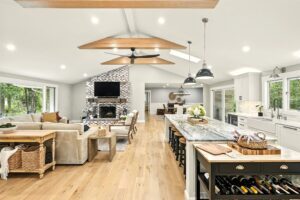 Spacious modern kitchen and living room with wooden floors and stylish decor.