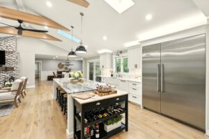 Bright, modern kitchen with a large island and stainless steel appliances.