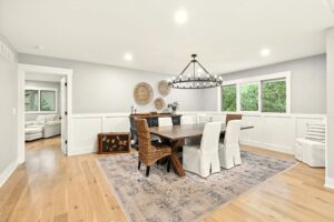 Modern dining room with mixed seating and elegant chandelier.