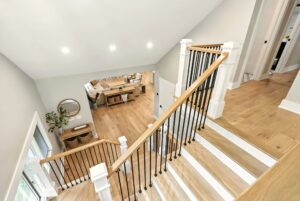 Bright modern home interior with wooden floors and staircase.