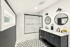 Modern bathroom with black and white hex tile floor and double vanity.