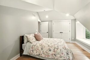 Cozy bedroom with floral bedding and soft lighting.