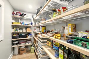 A well-stocked pantry with organized shelves full of food items.