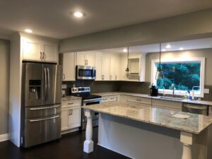 Modern kitchen with stainless steel appliances and granite countertops.
