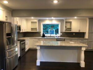 Modern kitchen with white cabinets and a large island.