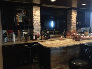 Cozy kitchen with stone accents and granite countertops.