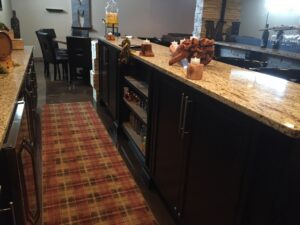 Cozy restaurant interior with a granite countertop and wooden shelves.