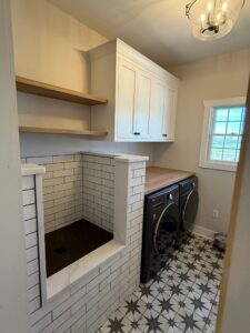 Laundry room with washer, dryer, and built-in ironing station.