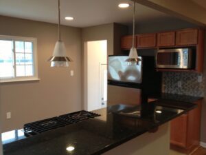 Modern kitchen with granite countertops and stainless steel appliances.