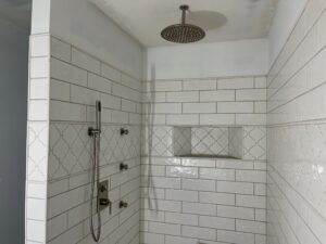 Modern shower with white subway tiles and built-in niche.