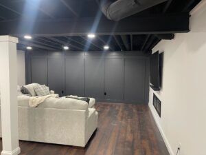 Cozy modern living room with sectional sofa and wall-mounted TV.