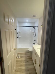 Clean bathroom with white bathtub and vanity.
