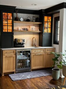 Cozy kitchen corner with wooden cabinets and a built-in wine cooler.