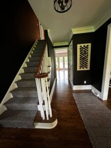 Cozy home interior with carpeted stairs and dark walls.