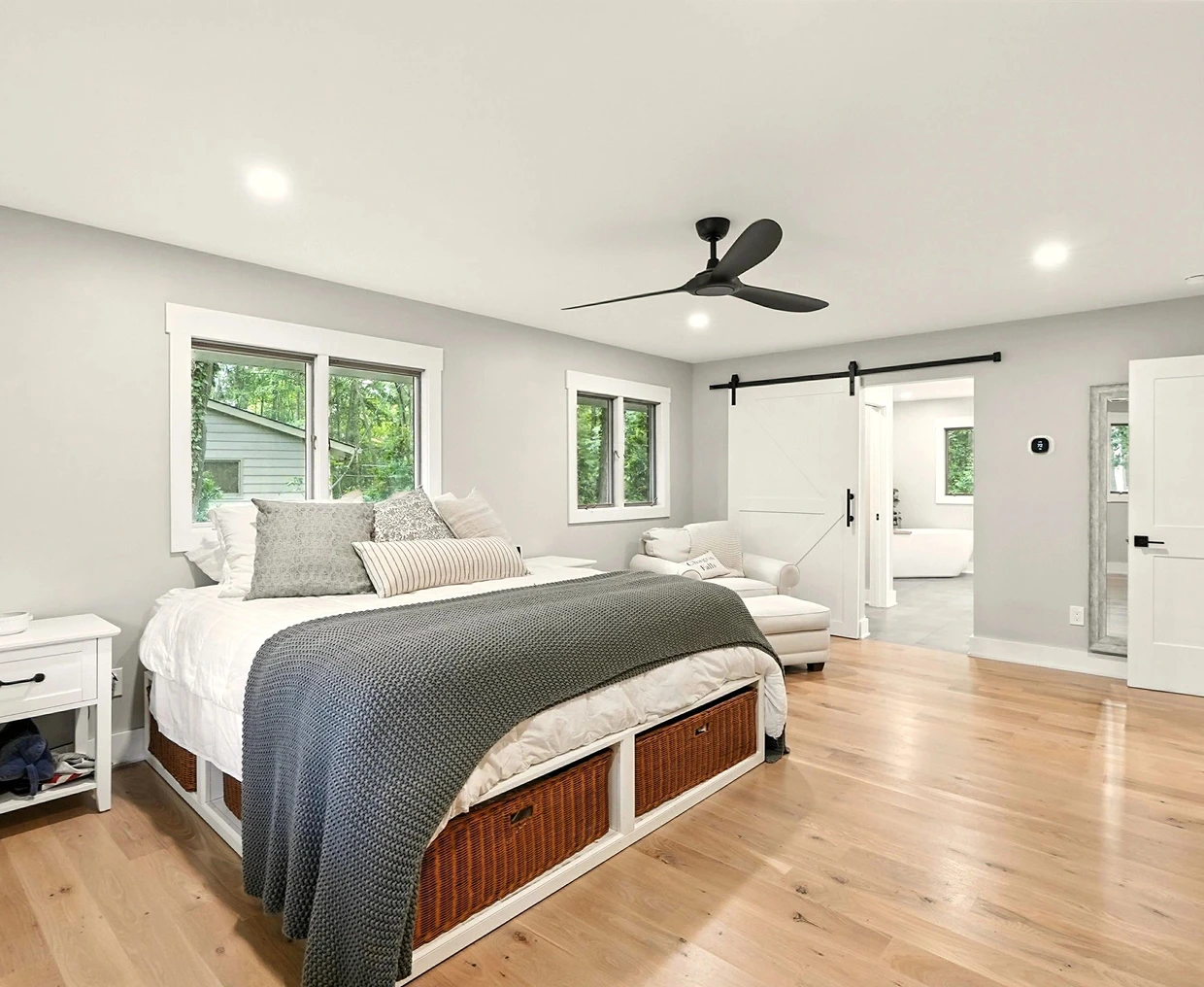 Modern bedroom with cozy bed and natural light.